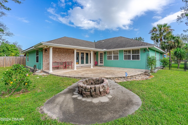 back of property featuring a yard and a patio area