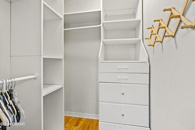 walk in closet with light wood-type flooring