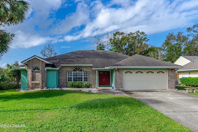 ranch-style house featuring a garage and a front lawn