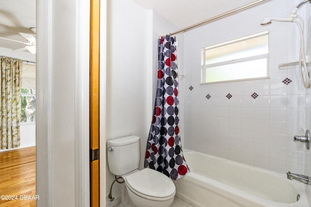 bathroom featuring shower / tub combo with curtain, toilet, and hardwood / wood-style flooring