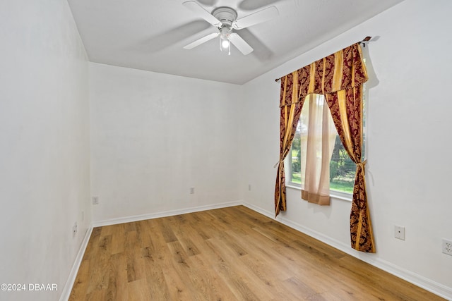 spare room with light hardwood / wood-style floors and ceiling fan