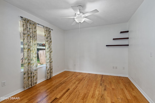 spare room featuring light wood-type flooring and ceiling fan