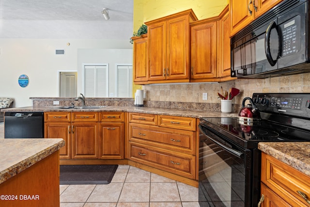 kitchen featuring black appliances, tasteful backsplash, a textured ceiling, light tile patterned floors, and sink