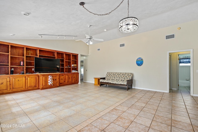 unfurnished living room featuring built in shelves, ceiling fan with notable chandelier, a textured ceiling, light tile patterned floors, and lofted ceiling