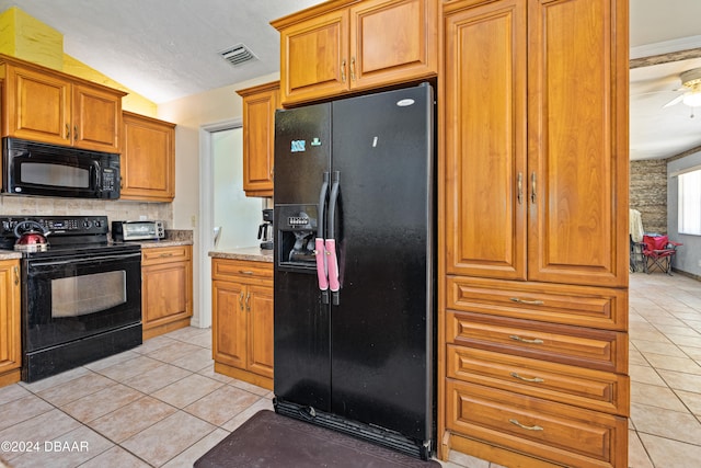 kitchen with lofted ceiling, black appliances, light tile patterned floors, ceiling fan, and backsplash