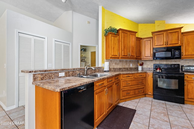 kitchen featuring a textured ceiling, black appliances, sink, and light tile patterned floors