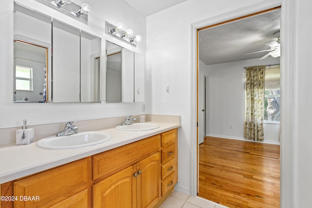 bathroom featuring hardwood / wood-style floors, plenty of natural light, vanity, and ceiling fan