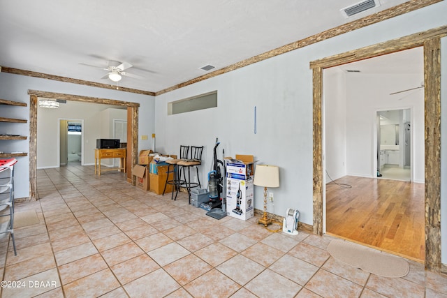 living room with light hardwood / wood-style floors and ceiling fan