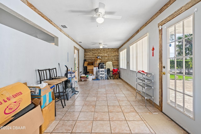 sunroom / solarium featuring ceiling fan