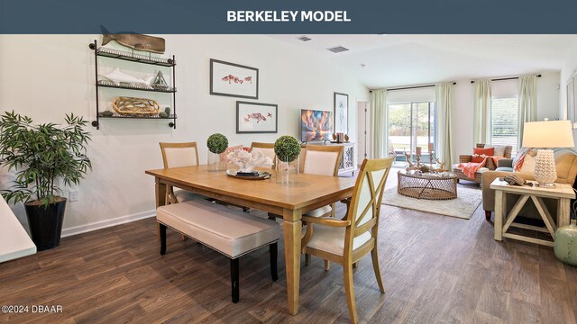 dining room featuring lofted ceiling and dark hardwood / wood-style floors