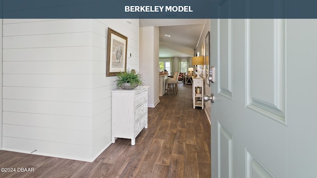 hall with vaulted ceiling and dark hardwood / wood-style floors