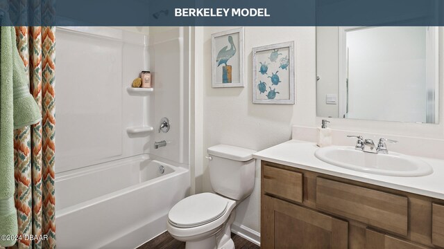 full bathroom featuring hardwood / wood-style floors, vanity, shower / bath combo with shower curtain, and toilet