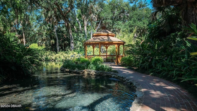 view of property's community featuring a water view and a gazebo