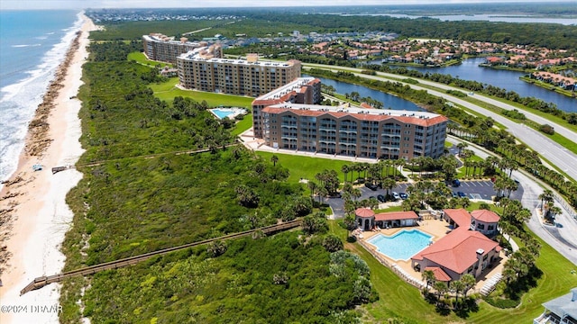 drone / aerial view with a water view and a beach view