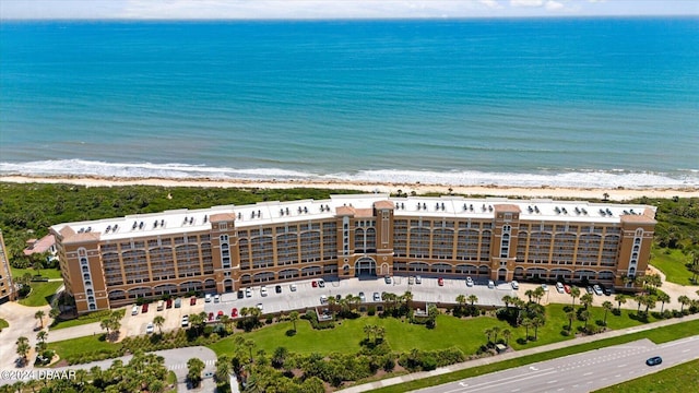 birds eye view of property with a water view and a view of the beach