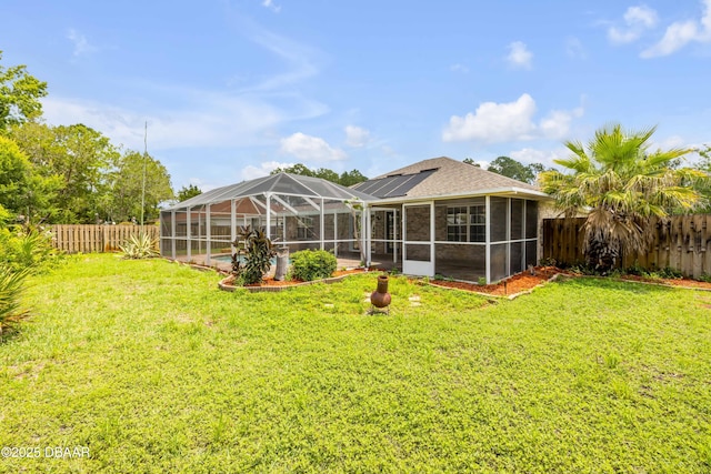 20 Potters Ln, Palm Coast, FL 32164 - rear view of house featuring a sunroom, solar panels, and roof with shingles