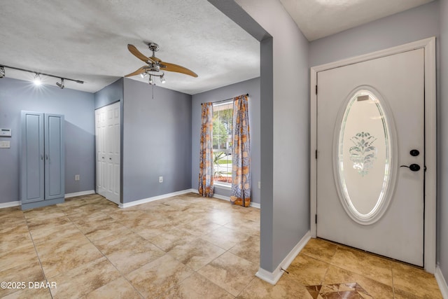 20 Potters Ln, Palm Coast, FL 32164 - tiled entrance foyer with a ceiling fan, baseboards, a textured ceiling, and track lighting