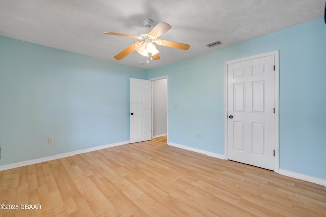 20 Potters Ln, Palm Coast, FL 32164 - unfurnished bedroom featuring wood finished floors, baseboards, and a ceiling fan