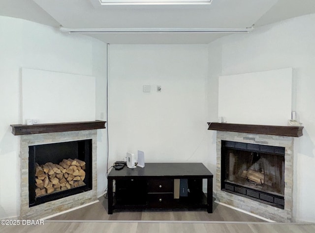living room featuring wood finished floors and a fireplace