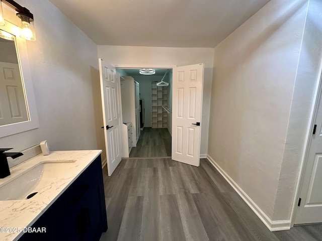 bathroom with vanity, baseboards, and wood finished floors
