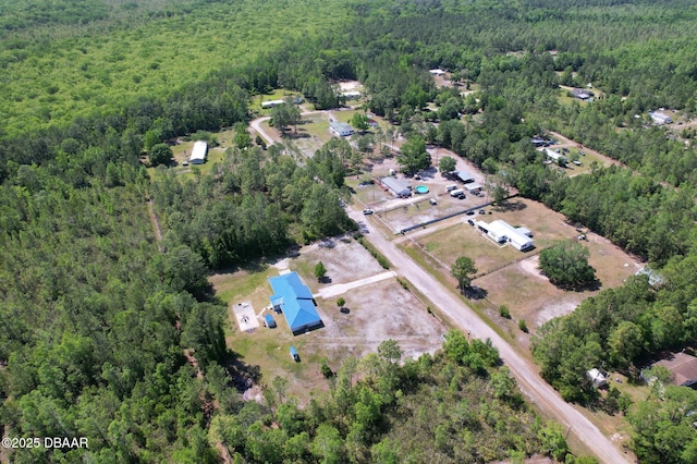 drone / aerial view with a wooded view