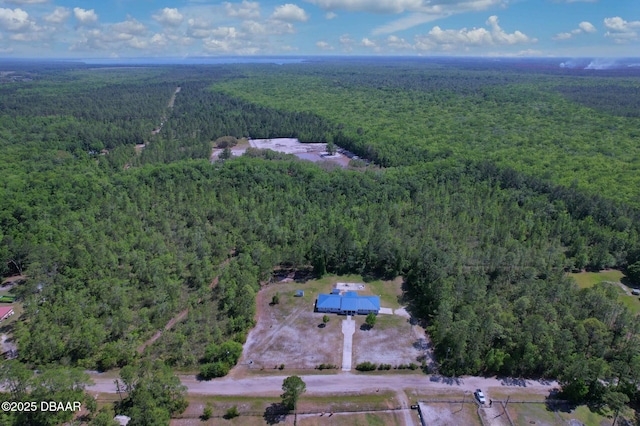 birds eye view of property featuring a view of trees