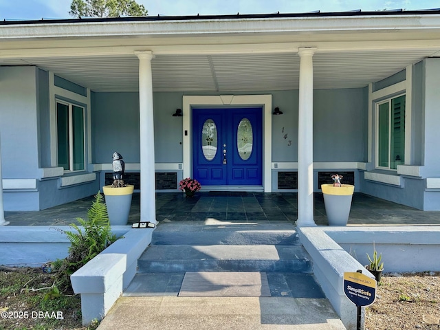 view of exterior entry with a porch