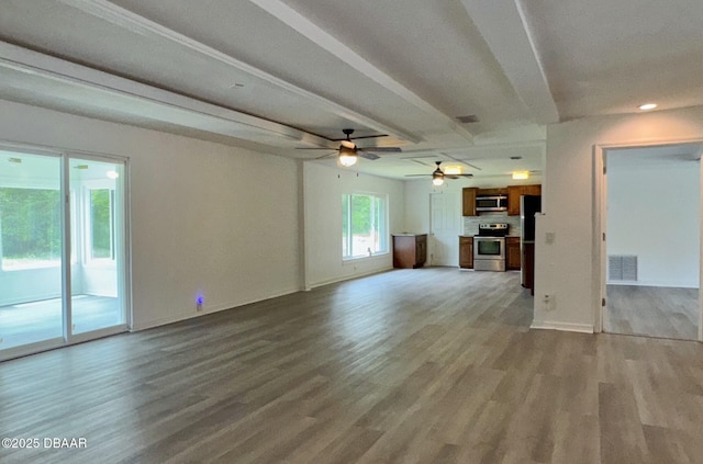 unfurnished living room featuring a ceiling fan, baseboards, visible vents, and light wood-type flooring