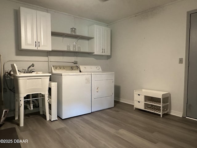 143 Pinecrest Cir, San Mateo, FL 32187 - laundry room featuring washing machine and dryer, cabinet space, dark wood finished floors, and baseboards