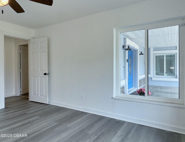 unfurnished room featuring baseboards, ceiling fan, and wood finished floors