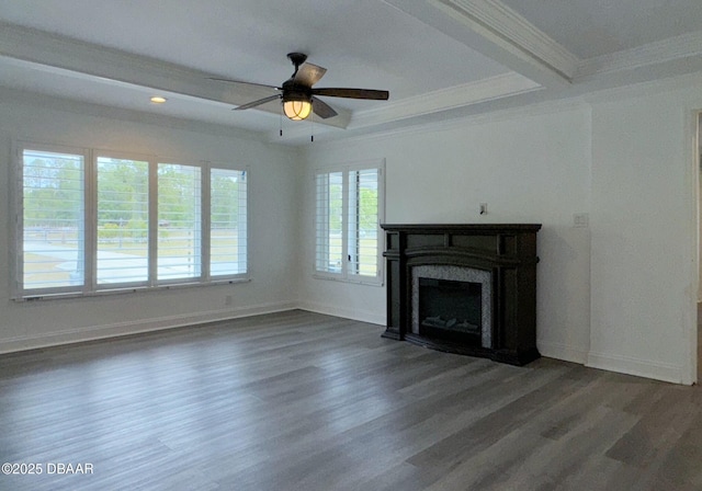 unfurnished living room featuring a ceiling fan, crown molding, a high end fireplace, wood finished floors, and baseboards