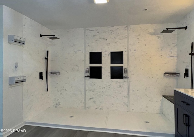 bathroom featuring a walk in shower, vanity, and wood finished floors