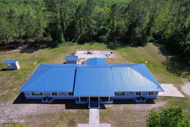 drone / aerial view featuring a view of trees