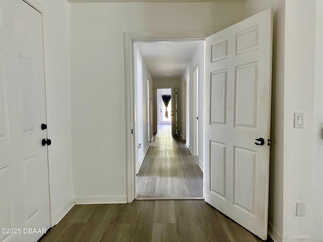 hallway with baseboards and dark wood finished floors