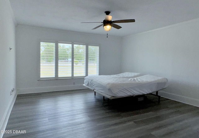 bedroom with baseboards, ceiling fan, and wood finished floors