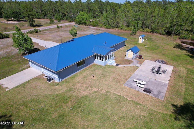 birds eye view of property with a view of trees