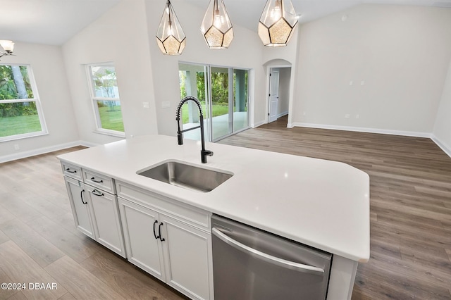 kitchen with light hardwood / wood-style floors, lofted ceiling, dishwasher, sink, and decorative light fixtures