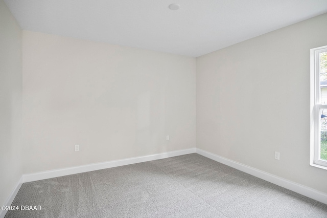 carpeted empty room with a wealth of natural light