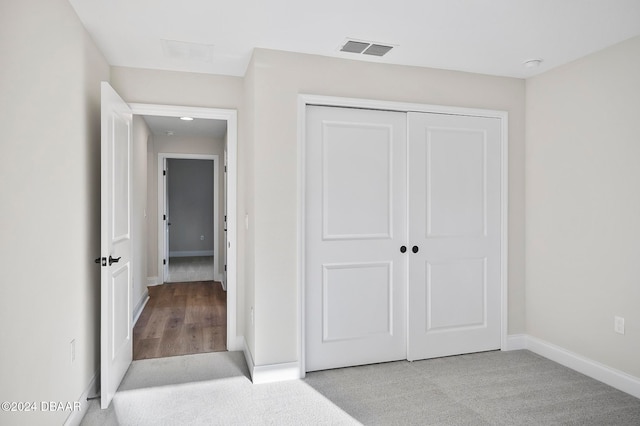 interior space featuring a closet and light carpet