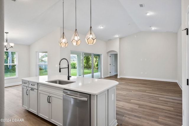 kitchen with hardwood / wood-style flooring, a center island with sink, sink, stainless steel dishwasher, and lofted ceiling