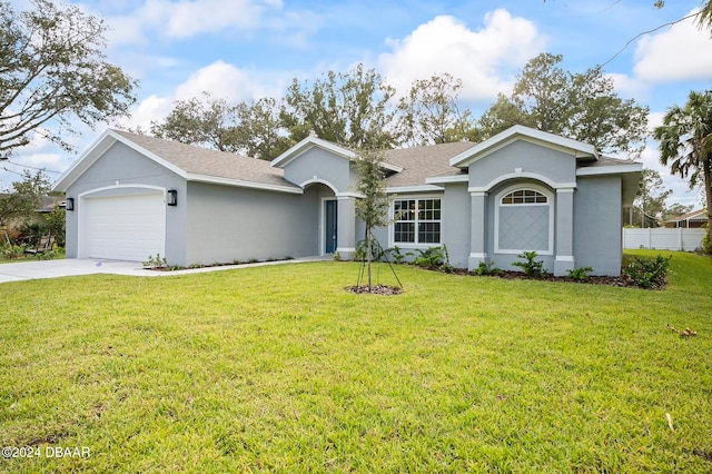 ranch-style home featuring a garage and a front lawn