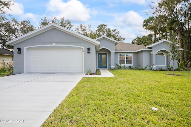 single story home with a garage and a front lawn