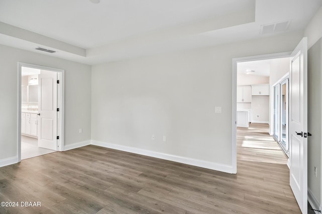 spare room featuring wood-type flooring