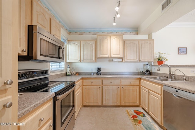 kitchen with appliances with stainless steel finishes, light brown cabinets, ornamental molding, and sink