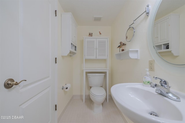 bathroom featuring sink and toilet