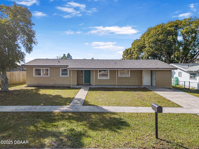 single story home featuring a front lawn