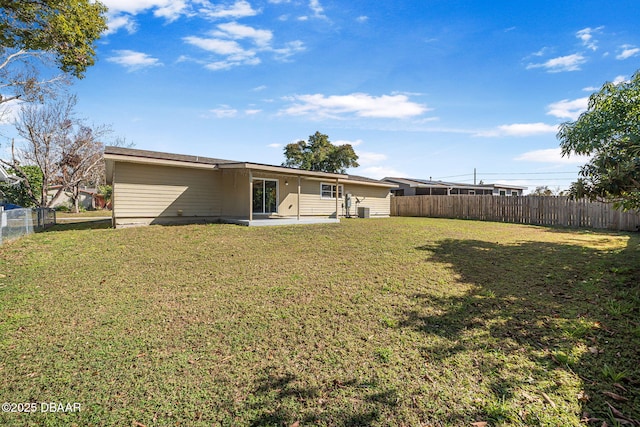 rear view of house with a patio area and a lawn