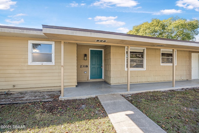 doorway to property featuring a porch