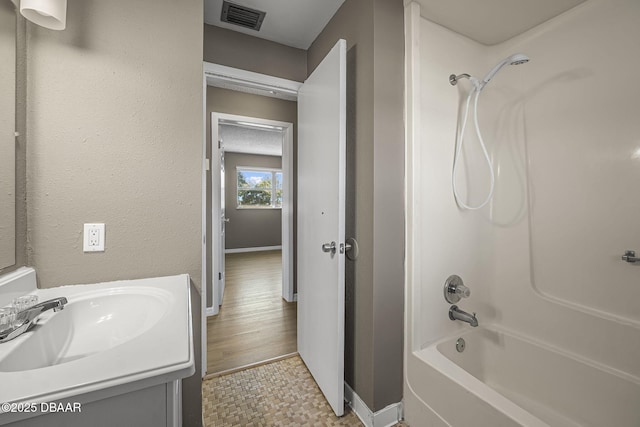 bathroom featuring shower / tub combination, vanity, and tile patterned flooring