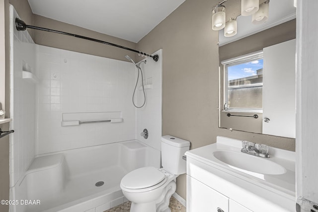 bathroom with vanity, toilet, and a shower